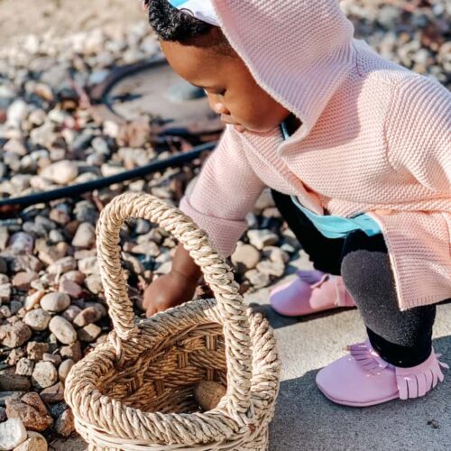 Toddler Playing With Rocks Outside